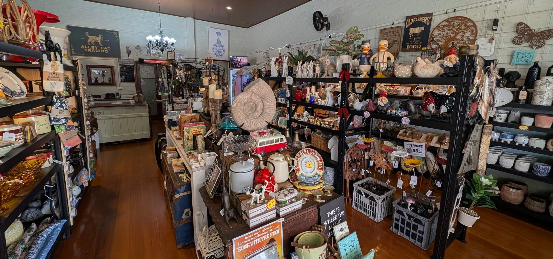 Nostalgic store interior with various collectibles and decor items on shelves.slider_item_qVpjjj